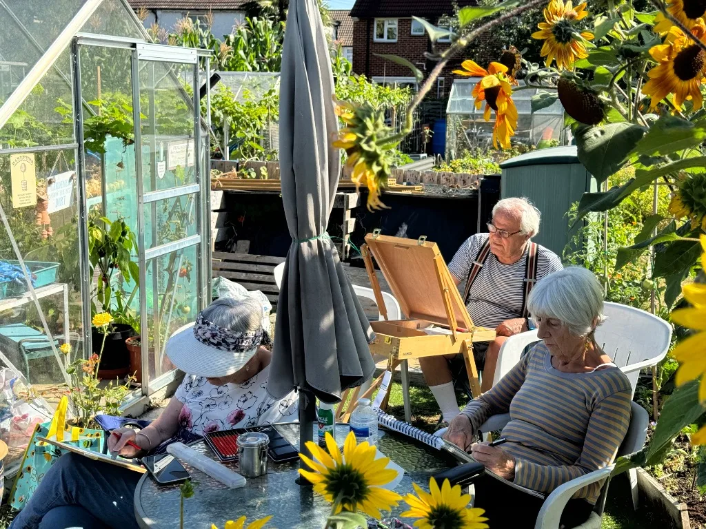 Carshalton & Wallington Art Group members painting outdoors among sunflowers
