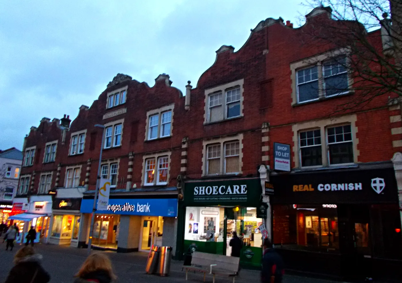 Shops on Sutton High Street. The gas main closure is at the Burnell Road junction, north of the pedestrianised stretch.